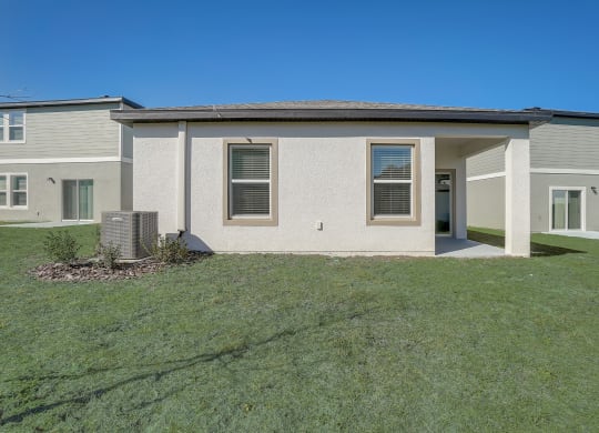 Backyard with lush green grass of the Oak floor plan at Beacon at Clinton Corners in Dade City, FL