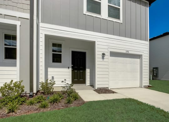 Exterior of single family rental house with garage and driveway at Beacon at Arbours in Ruskin, FL