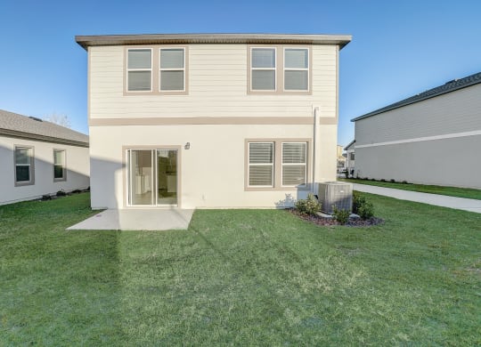 Backyard with lush green grass of the Maple floor plan at Beacon at Clinton Corners in Dade City, FL
