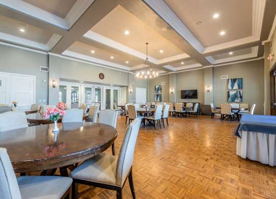 Grand ballroom with tables, chairs, and a tv at Encore at Buckingham apartments in Richardson, TX