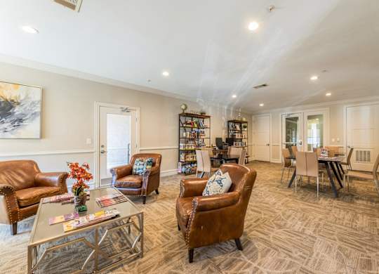 Game room with computers and printer, board games, and single seat couches beside a fireplace at Encore at Buckingham apartments in Richardson, TX