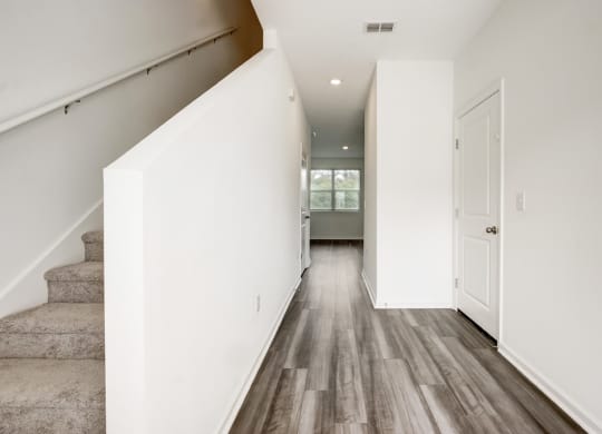Entry overlooking staircase and hallway to living room and kitchen area at Beacon at Arbours in Ruskin, FL