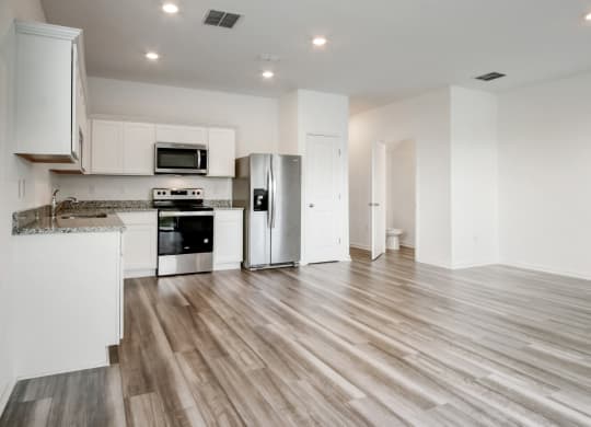 Spacious living and kitchen area with modern design at Beacon at Arbours in Ruskin, FL