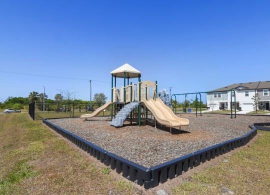 a playground with a slide and climbing structure at Beacon at Arbours, Ruskin, 33570