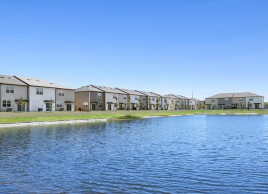 a large body of water in front of a row of houses at Beacon at Arbours, Florida