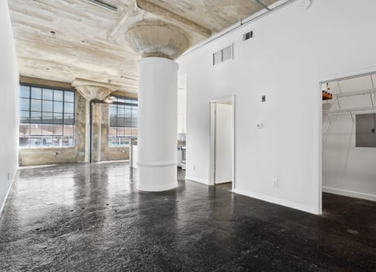 Entrance into loft apartment with white walls and large support column adding an urban touch | Adam Hats Lofts from Deep Ellum Lofts in Dallas, TX