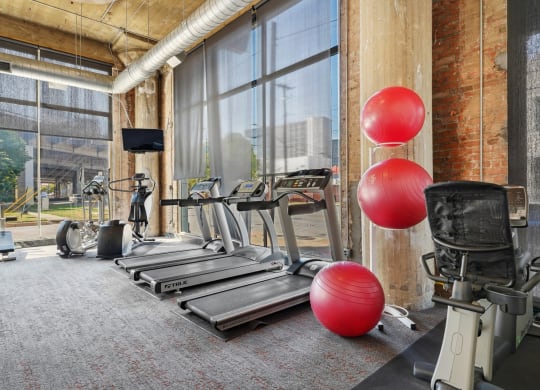 Adam Hats fitness center with treadmills and other cardio equipment | Adam Hats Lofts from Deep Ellum Lofts in Dallas, TX