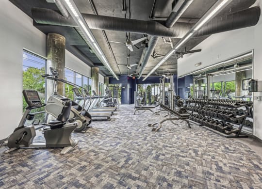 State-of-the-art fitness center with a variety of exercise equipment at Allusion at West University apartments in Houston, TX