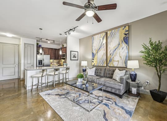 a living room with a couch and a ceiling fan