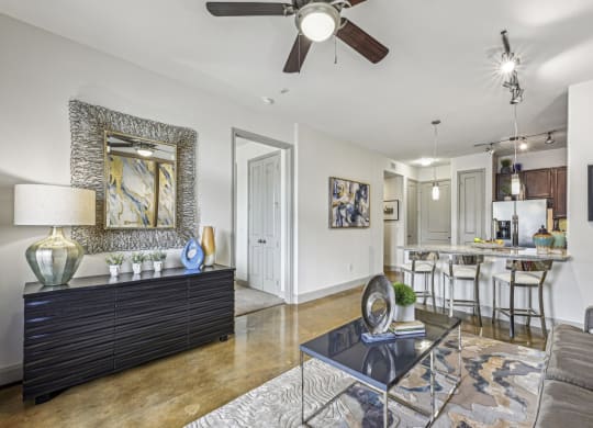 Elegant living area with stylish decor and modern furnishings at Allusion at West University apartments in Houston, TX