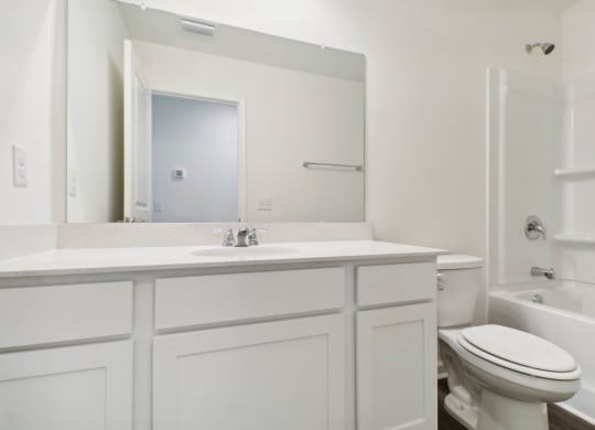 Bright bathroom featuring a spacious countertop and a combined shower and tub at Beacon at Ashley River Landing in Summerville, SC