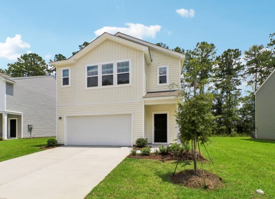 Front view of the apartment, highlighting the main entrance and surrounding greenery at Beacon at Ashley River Landing in Summerville, SC