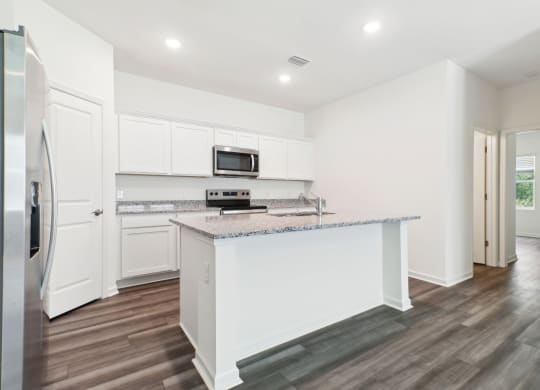Modern kitchen with stainless steel appliances and white cabinetry at Beacon at Ashley River Landing in Summerville, SC