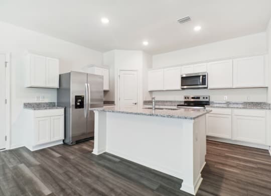 Spacious kitchen with island and granite countertops at Beacon at Ashley River Landing in Summerville, SC