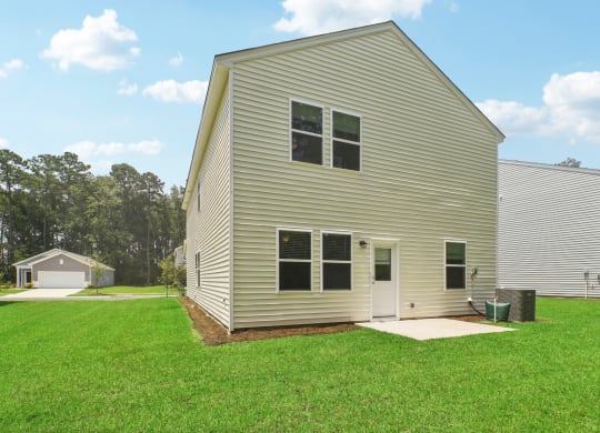 Front exterior view of a modern home with a landscaped yard at Beacon at Ashley River Landing in Summerville, SC