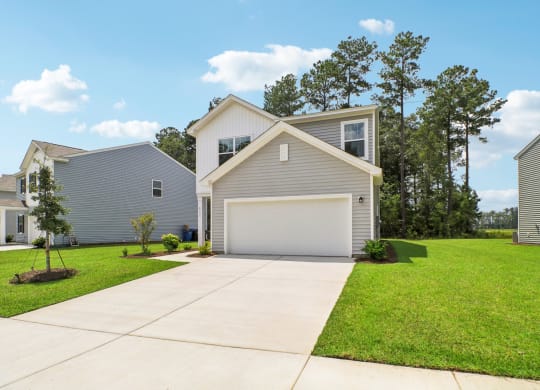 Side view of a two-story house with a white and gray exterior at Beacon at Ashley River Landing in Summerville, SC