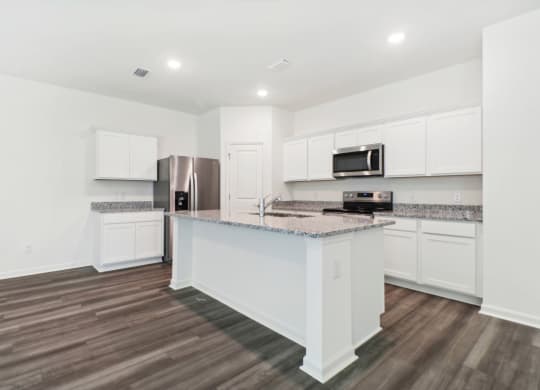 Maple kitchen with an island and a stainless steel at Beacon at Ashley River Landing in Summerville, SC