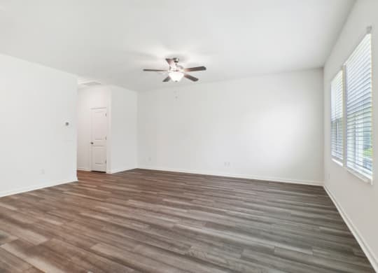 Maple living room with a ceiling fan and wood floor at Beacon at Ashley River Landing in Summerville, SC