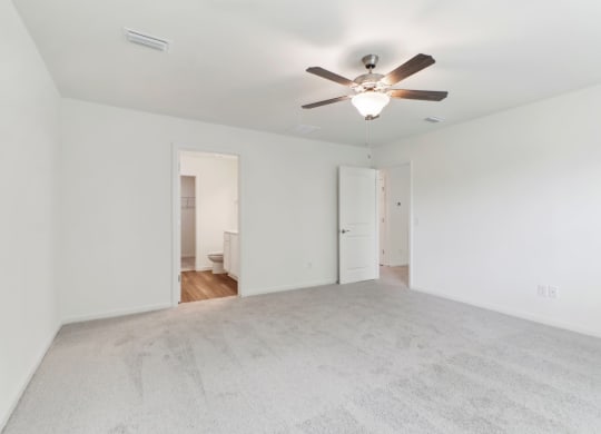 Maple bedroom with white walls and a ceiling fan at Beacon at Ashley River Landing in Summerville, SC