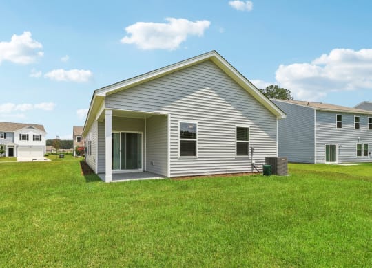 Side view of a single-story home with a covered patio at Beacon at Ashley River Landing in Summerville, SC