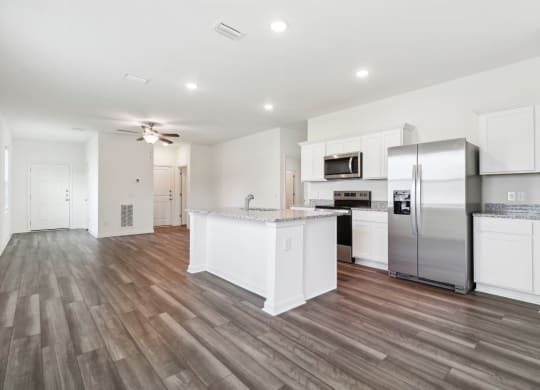 Oak open kitchen with a large island and stainless steel appliances at Beacon at Ashley River Landing in Summerville, SC