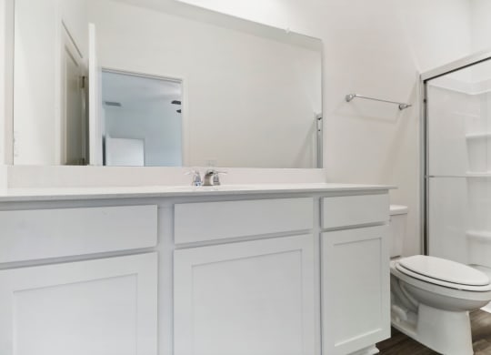Oak master bathroom with a glass-enclosed shower at Beacon at Ashley River Landing in Summerville, SC