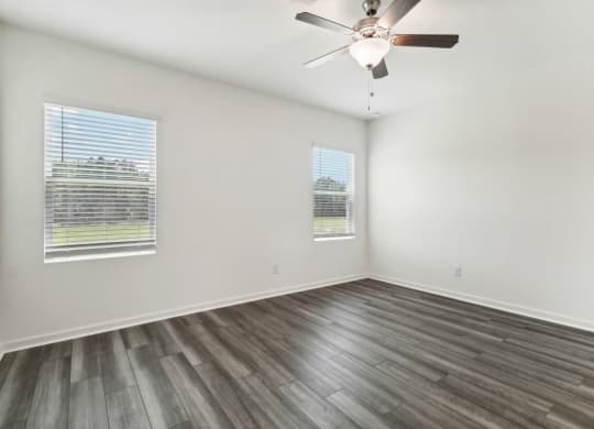 Oak bright and open living area with large windows at Beacon at Ashley River Landing in Summerville, SC