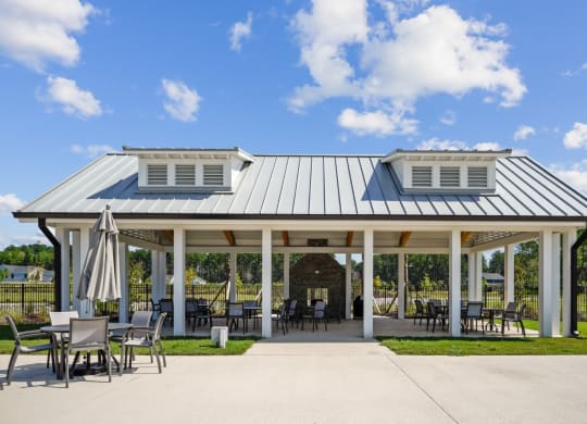 Pavilion next to pool and playground under a blue sky at at Beacon at Ashley River Landing in Summerville, SC