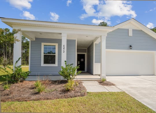 Front view of the Poplar floor home painted in a light blue at Beacon at Ashley River Landing in Summerville, SC