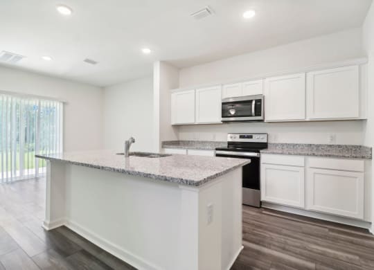 Sycamore kitchen with white cabinets and a counter top at Beacon at Ashley River Landing in Summerville, SC