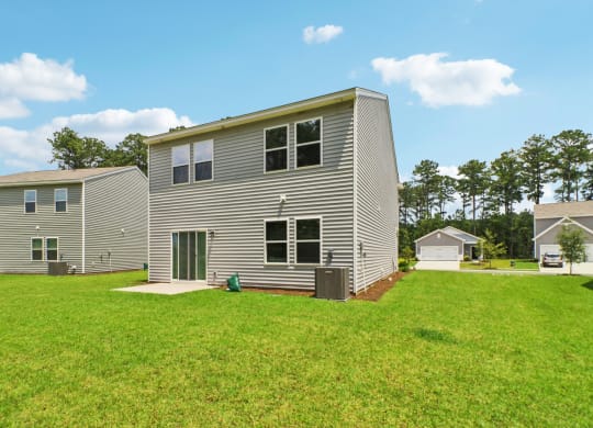 Large backyard space with air conditioning unit at Beacon at Ashley River Landing in Summerville, SC