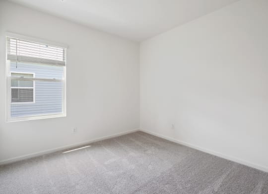 a bedroom with white walls and carpet at Beacon at Bunton Creek, Texas, 78640