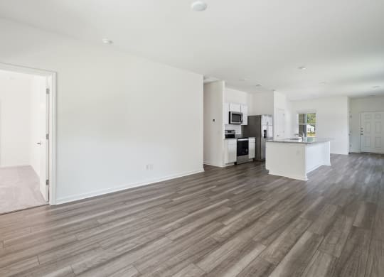 a living area with hardwood floors and white walls at Beacon at Meridian, San Antonio, TX