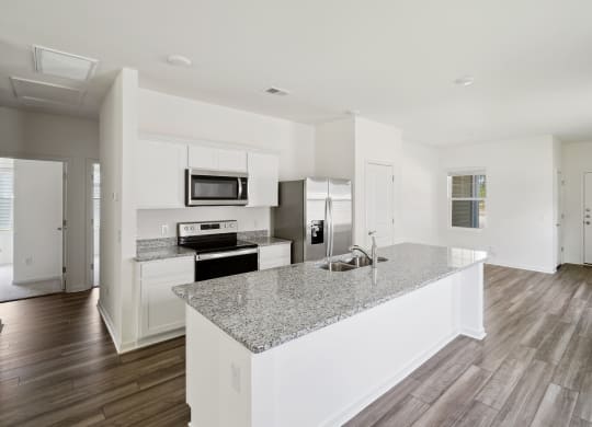 a kitchen with white cabinets and a granite counter top at Beacon at Meridian, Texas, 78245