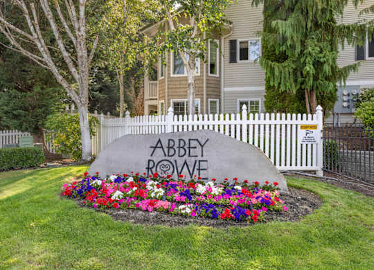 An entry sign for Abbey Rowe Apartments in Olympia, WA