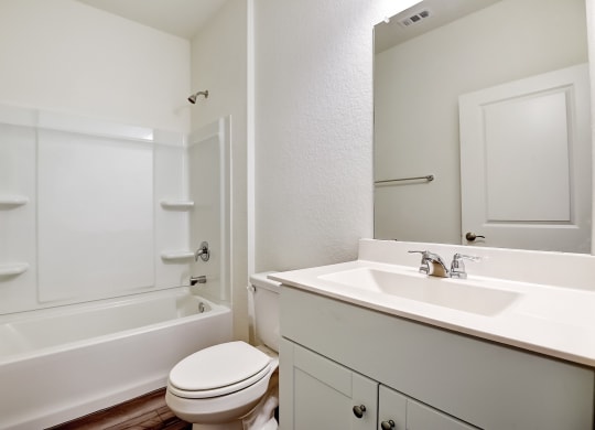 a bathroom with a toilet sink and bathtub at Beacon at Meridian, San Antonio, TX 78245