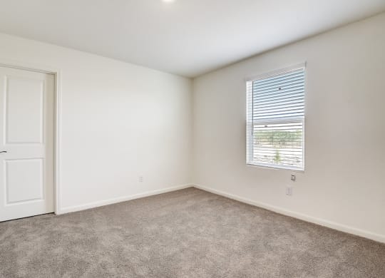 a bedroom with white walls and carpet at Beacon at Meridian, San Antonio, TX 78245