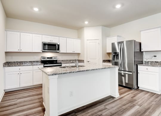 a kitchen with an island and stainless steel appliances at Beacon at Meridian, San Antonio Texas