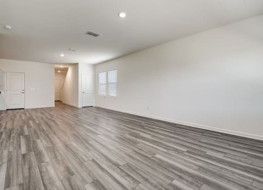 a bedroom with hardwood floors and white walls at Beacon at Meridian, San Antonio, TX