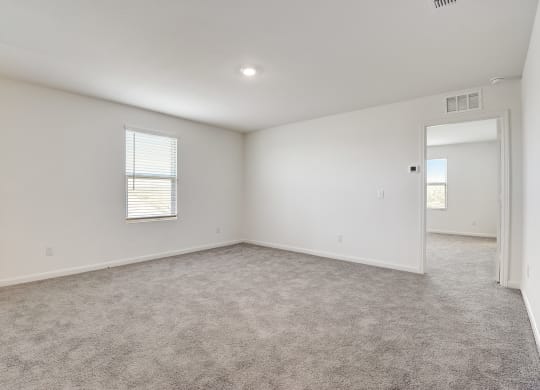 a bedroom with white walls and carpet