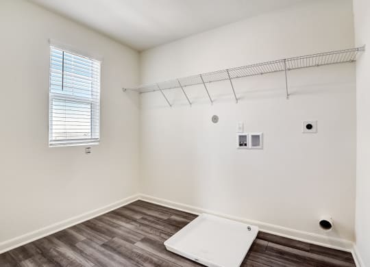 a bedroom with white walls and a window at Beacon at Meridian, Texas