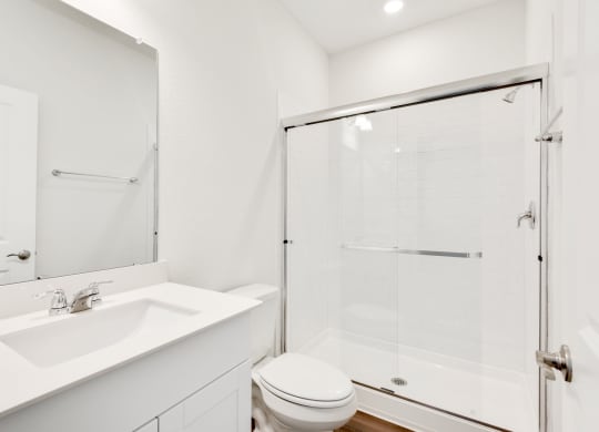 a bathroom with a toilet sink and shower