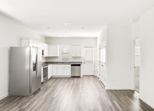 a kitchen with white cabinets and stainless steel appliances at Beacon at Meridian, San Antonio, 78245
