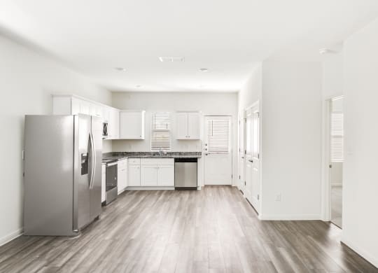 a kitchen with white cabinets and stainless steel appliances