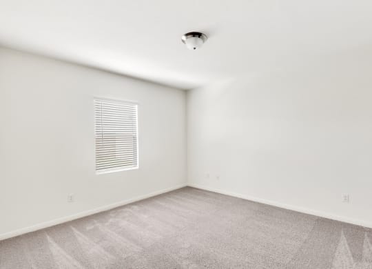 a bedroom with white walls and carpet