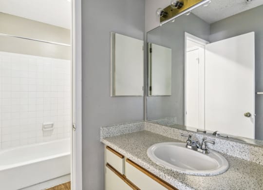 Modern bathroom with soaking tub at Bandera Crossing apartments in San Antonio, TX