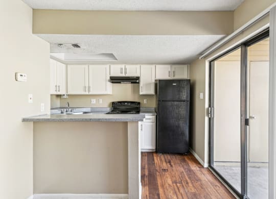 Gourmet kitchen with black appliances at Bandera Crossing apartments in San Antonio, TX