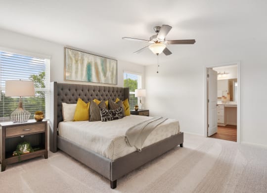 a bedroom with a bed and a ceiling fan at Beacon at Bunton Creek, Texas