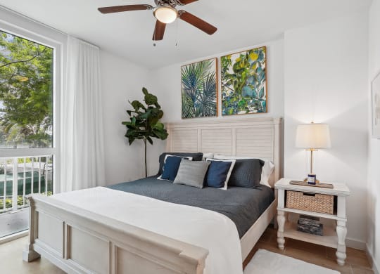 a bedroom with a bed and a ceiling fan