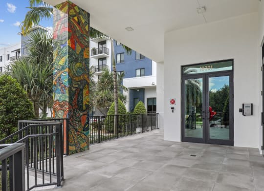 Entrance to our community lobby with pillars with artistic murals at Bay Village 1 in Palmetto Bay, FL